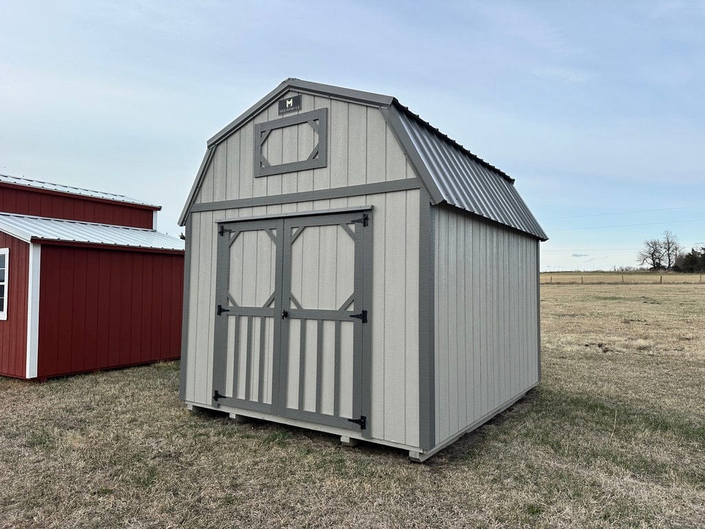 Exterior of a barn-style shed with double doors on the front of the lofted shed.