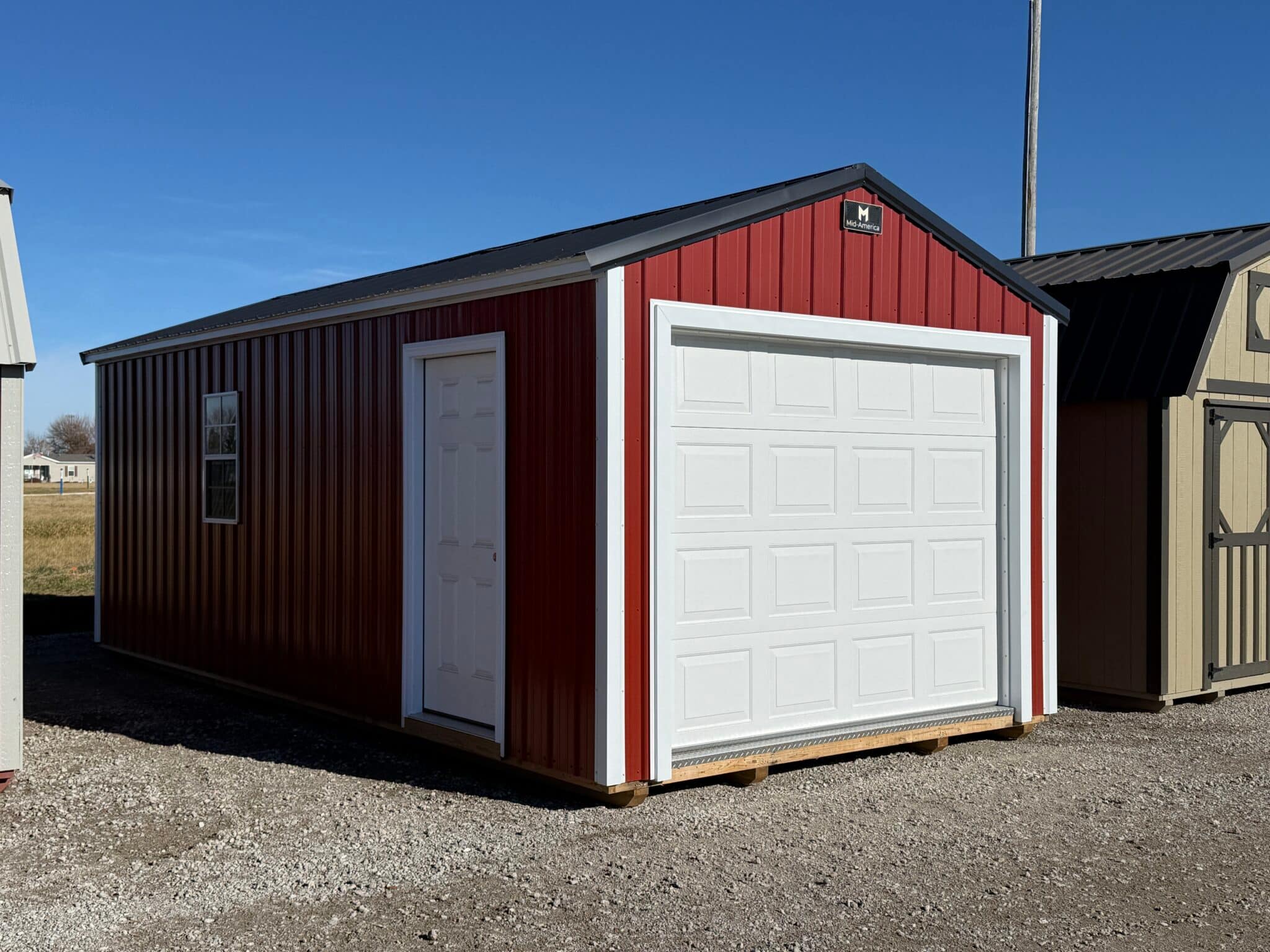 Small, red detached garage building.
