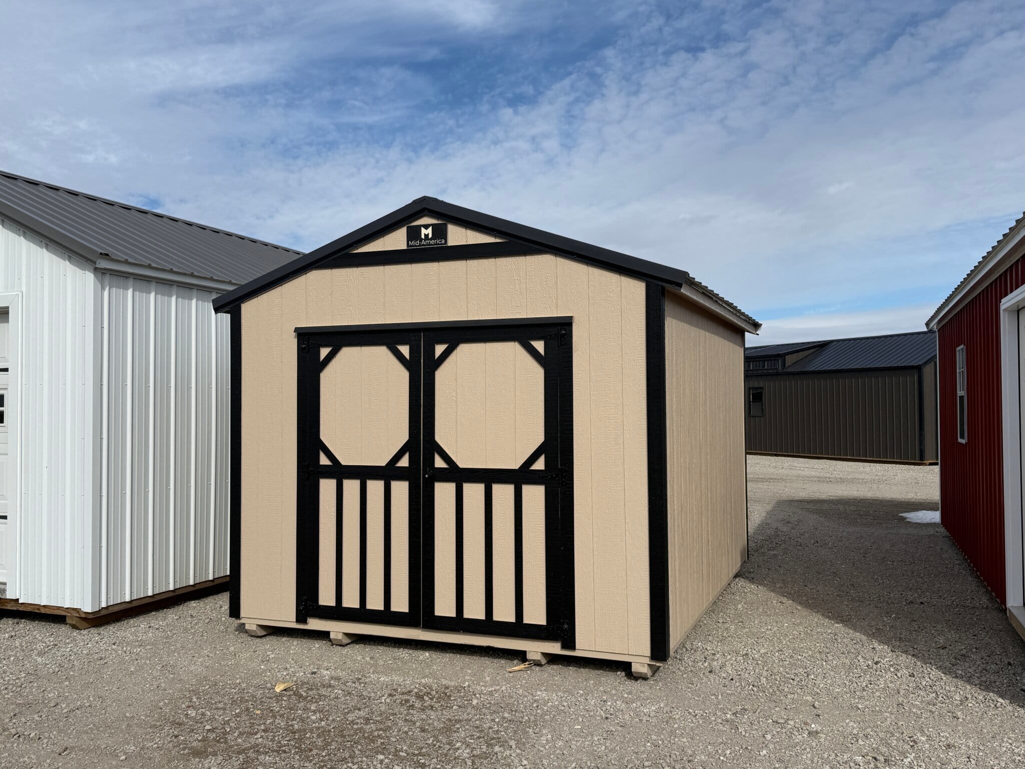 Small double-door, tan shed with dark brown accents.