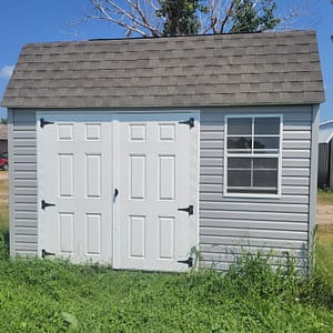 Exterior of small, double door storage shed with a small window