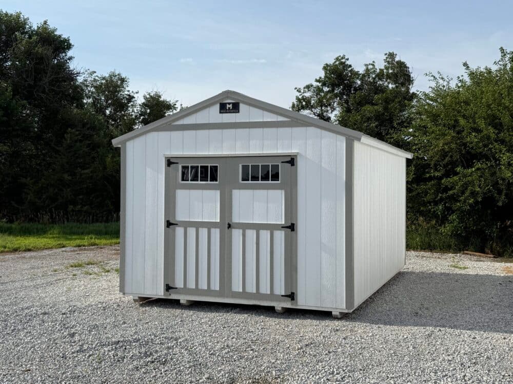 Exterior of white shed with grey trim