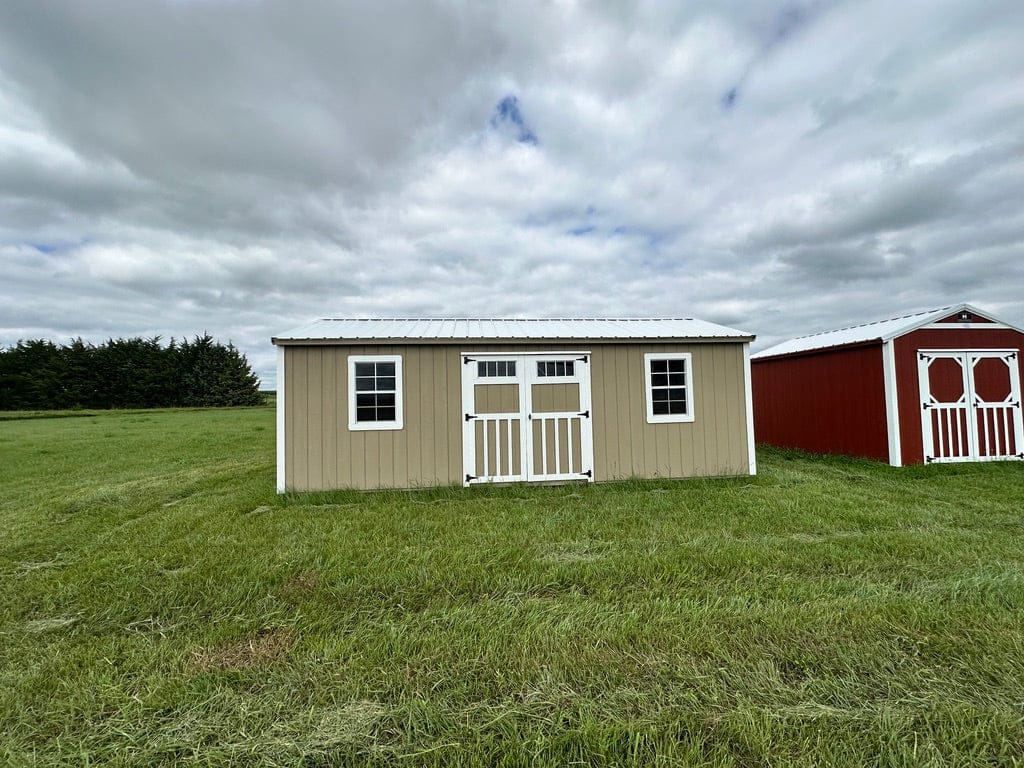 Exterior of large garden shed with double doors and two windows.