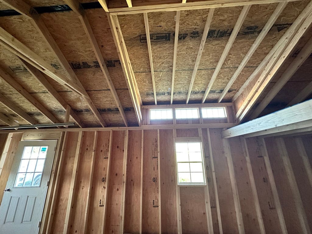 Interior of wood garage building showing windows and skylight.