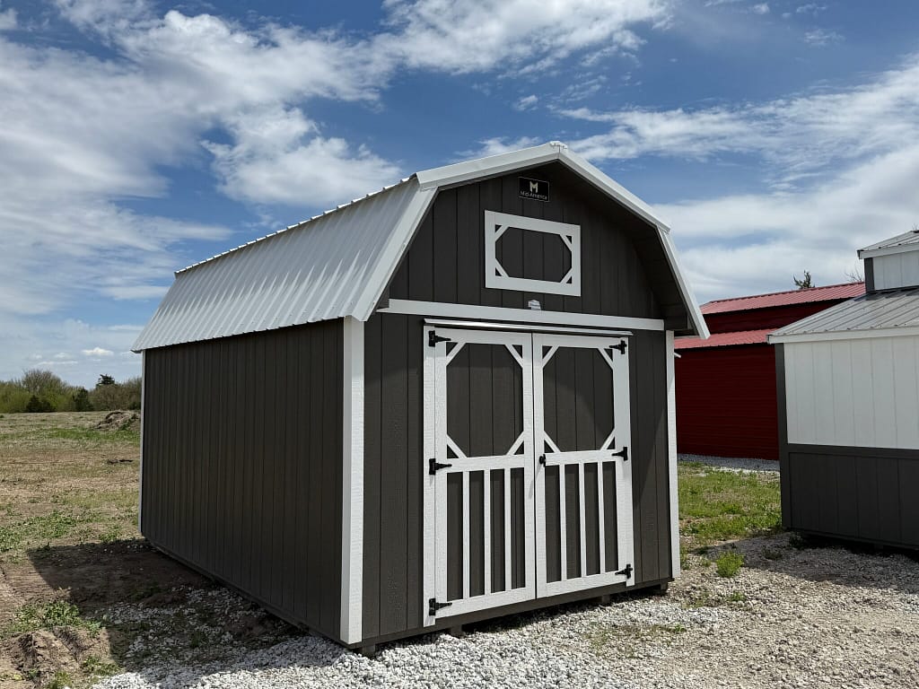 Exterior of small barn-shaped shed. Showcasing the double door front with a small loft window