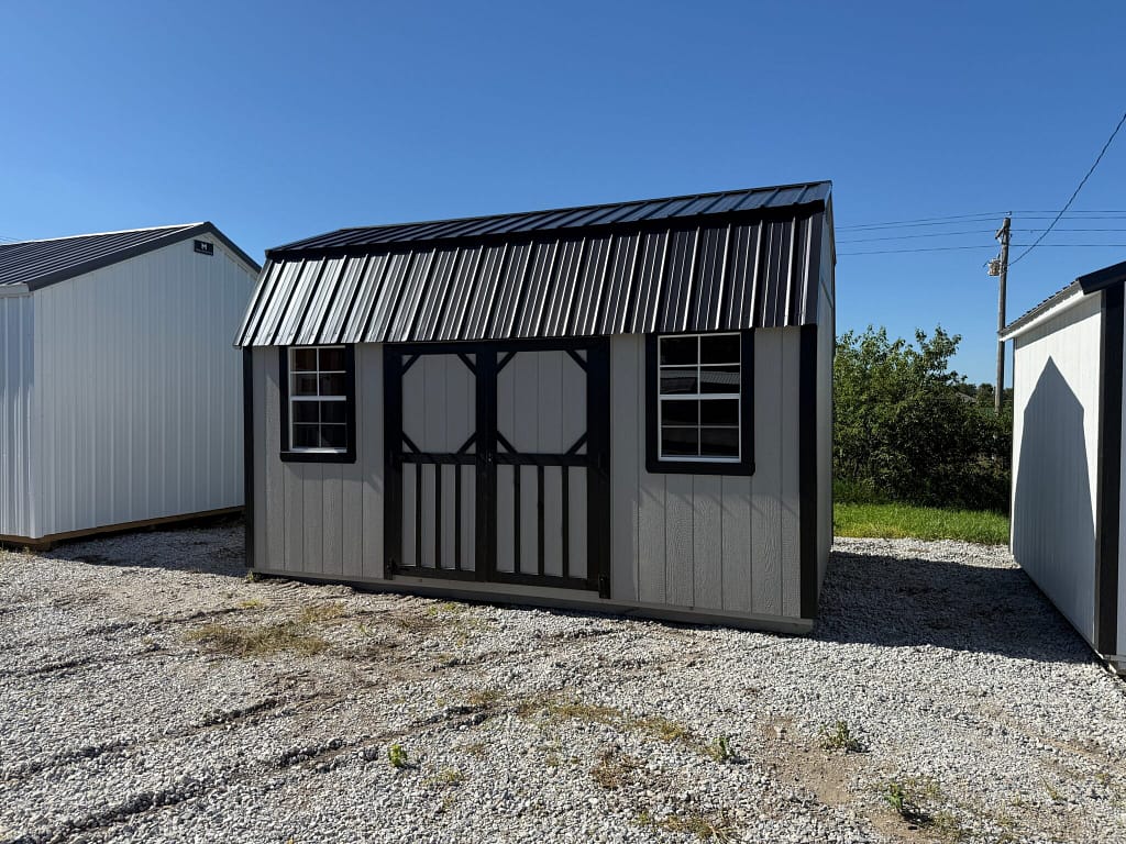 Exterior of large garden shed showcasing two windows.