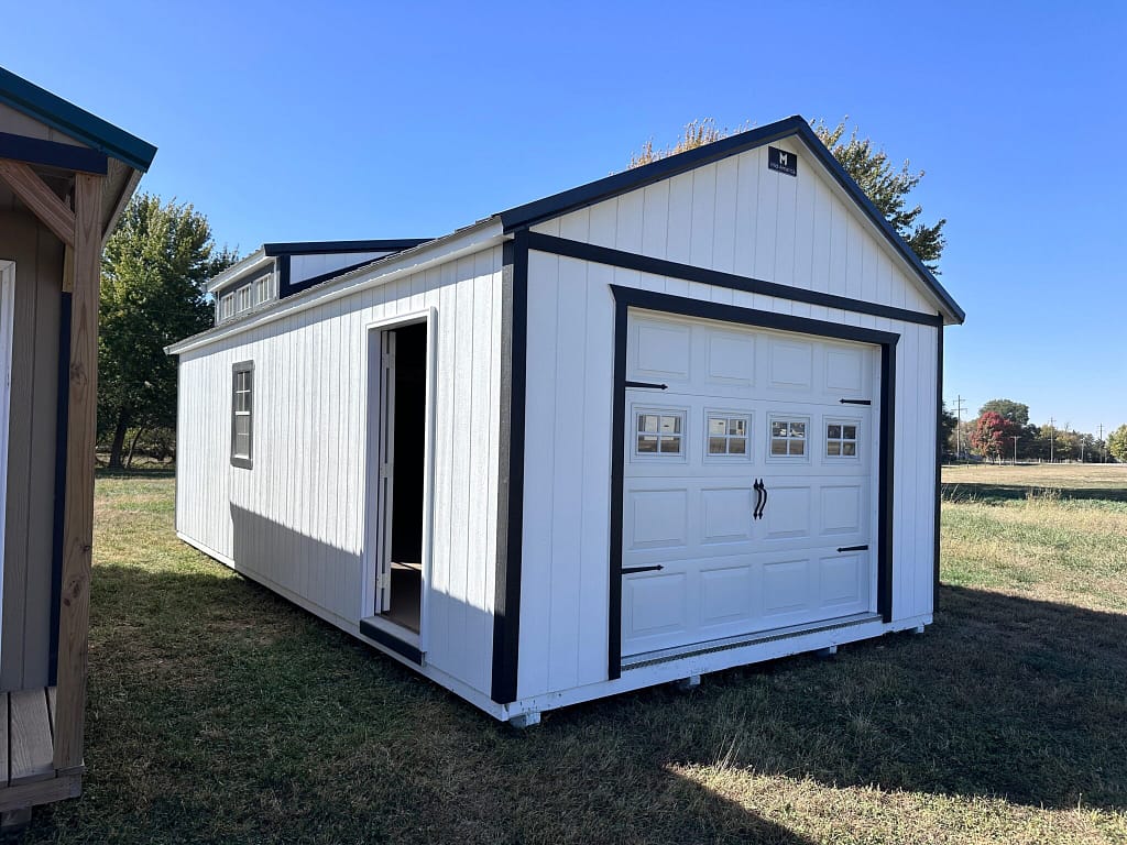 Exterior of white garage with single car garage door.