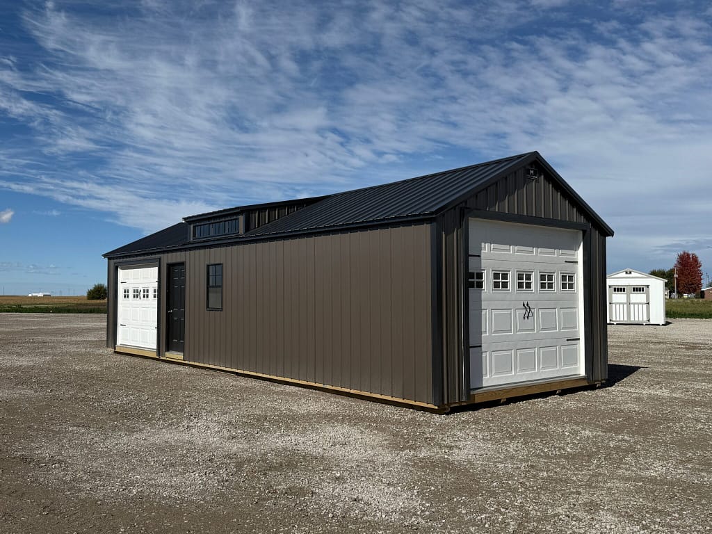 Exterior of garage showcasing the front door and garage door.