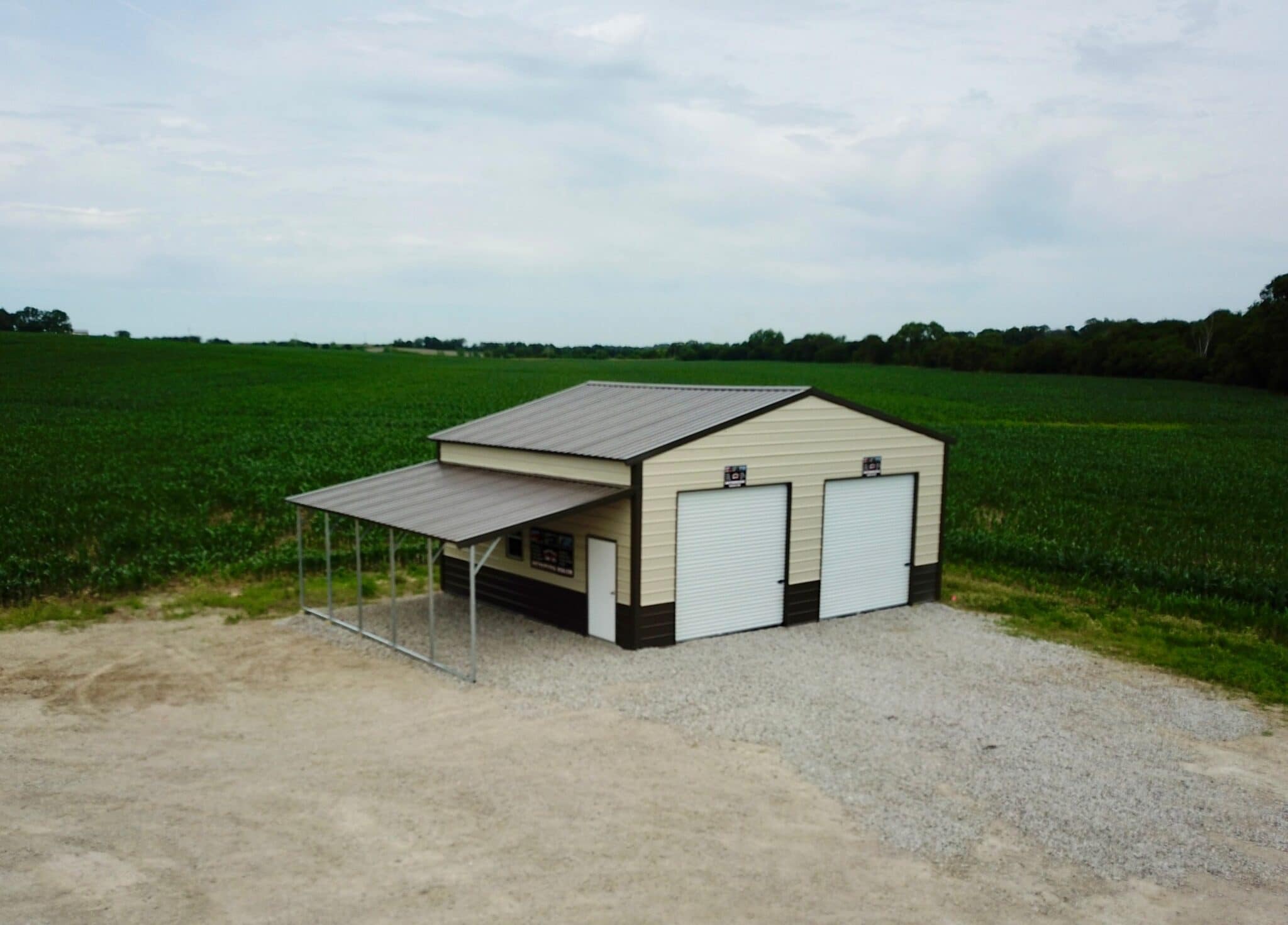 Exterior of a two-car garage structure with a lean-to attached to the side.