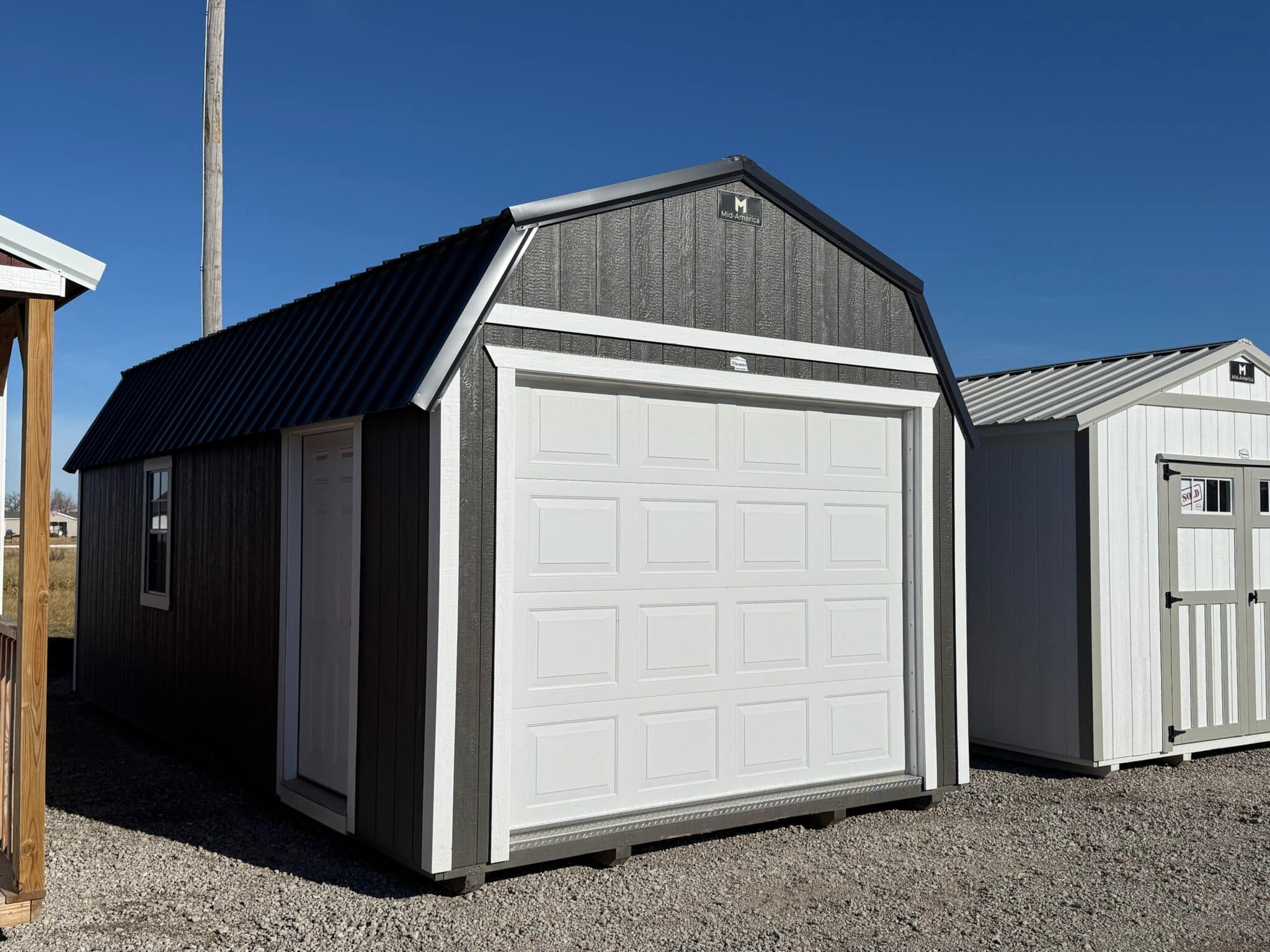 Small detached garage with a barn-style lofted roof.