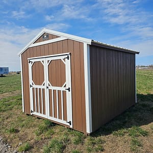 Exterior of small, double door utility shed with white trim