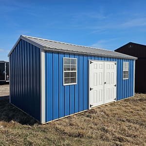 Exterior view of a long shed with a set of double doors and two windows.