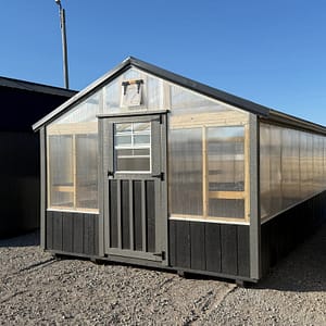 Greenhouse with black accents running around the bottom of the building.