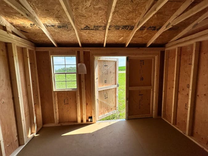 Interior of shed; looking out towards door and window