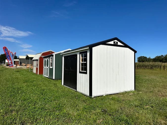 Exterior of white shed with black trim