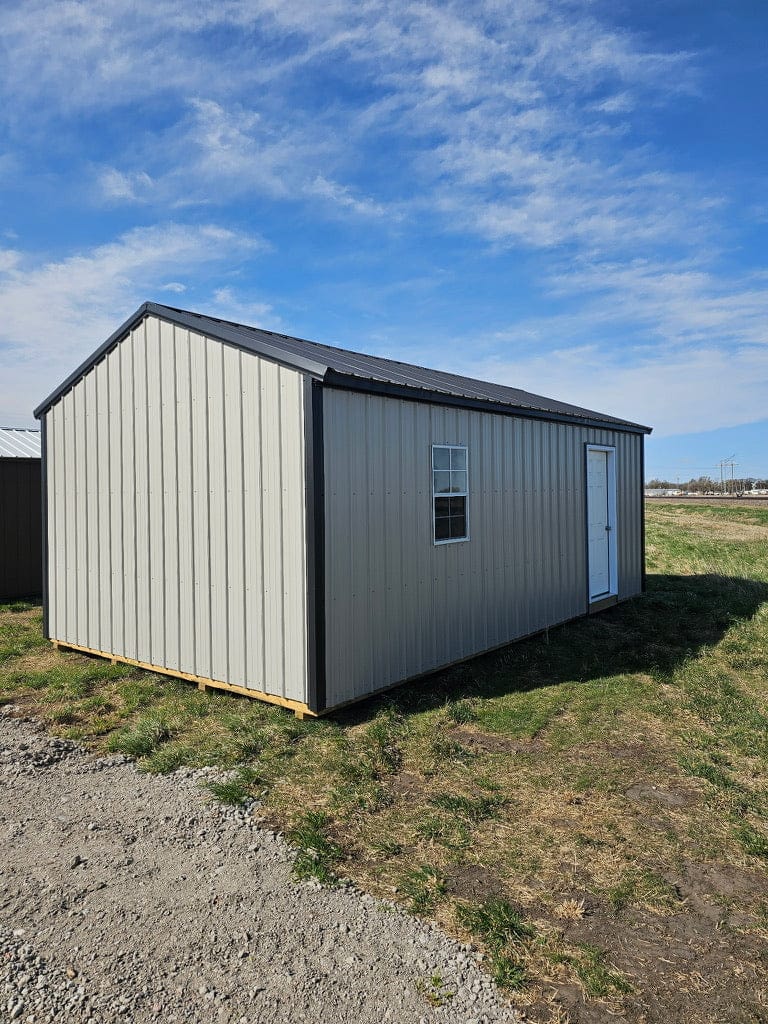 Exterior of the back of a garage showcasing a window and side door